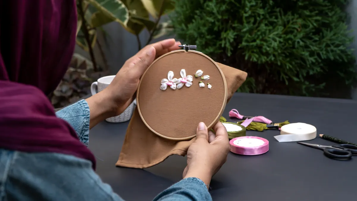 hands working embroidery in a hoop