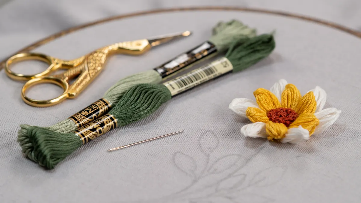Embroidery tools with a stitched flower